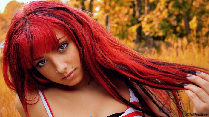 Woman with red hair and piercings
