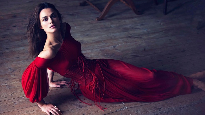 Keira Knightley in a red dress on a wooden floor