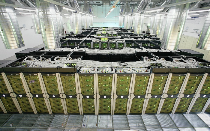 Server room with rows of computers and cables