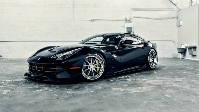 Black Ferrari F12 parked in a garage