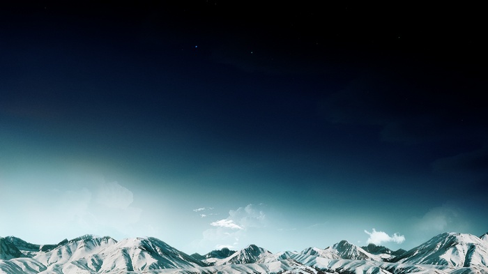 Snowy mountains under a starry night sky
