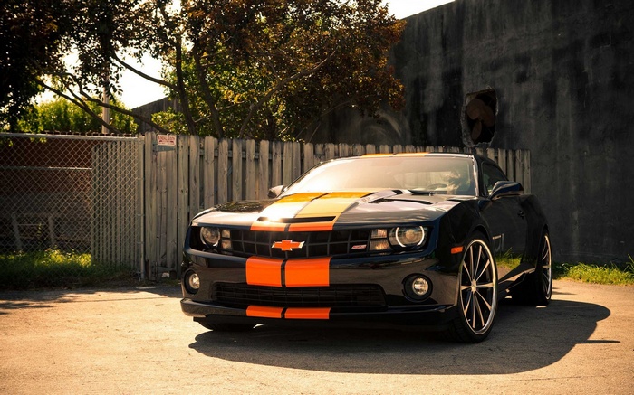 Black Chevrolet Camaro with orange stripes