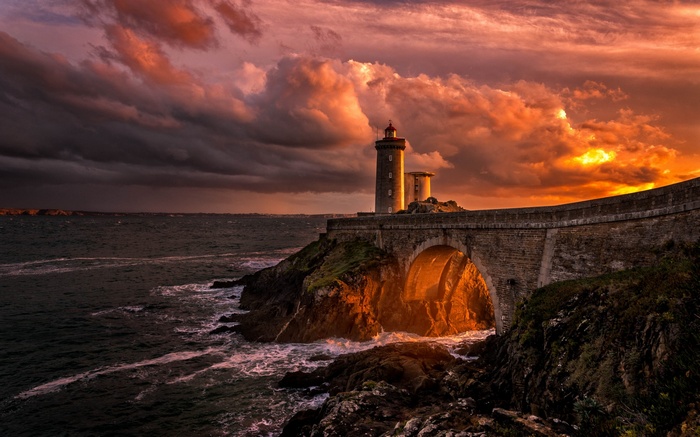Lighthouse and bridge in France at sunset