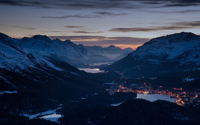 Evening in the Swiss Alps with a village by the lake