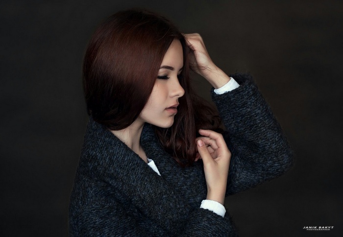 Woman with dark hair in a grey coat