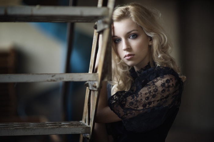 Portrait of a blonde woman in a black lace top