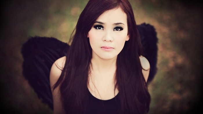 Asian woman with black wings