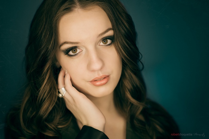 Woman with dark hair and ring