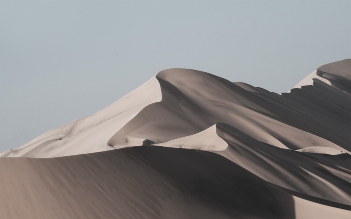 Sand dunes under a clear sky