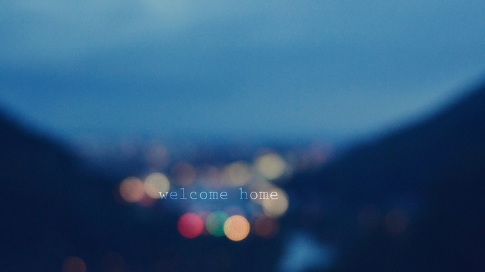Welcome home text over bokeh lights