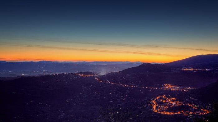 Cityscape at dusk with glowing lights