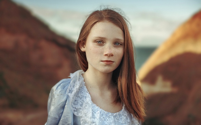 Young redhead girl with blue eyes and freckles