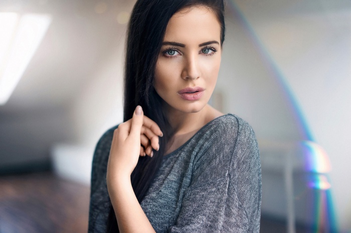 Woman with dark hair and blue eyes