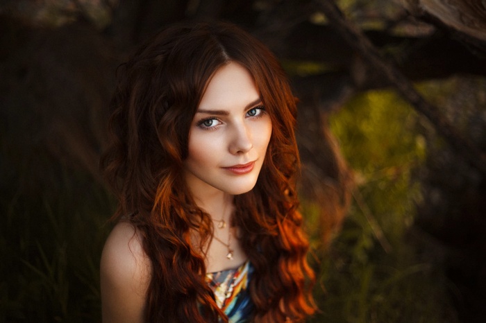 Portrait of a young woman with long red hair