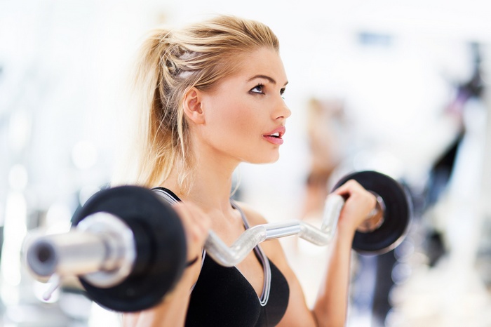 Woman lifting weights in a gym