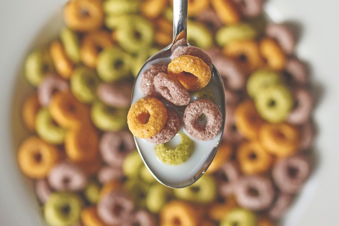 Spoonful of colorful cereal with milk
