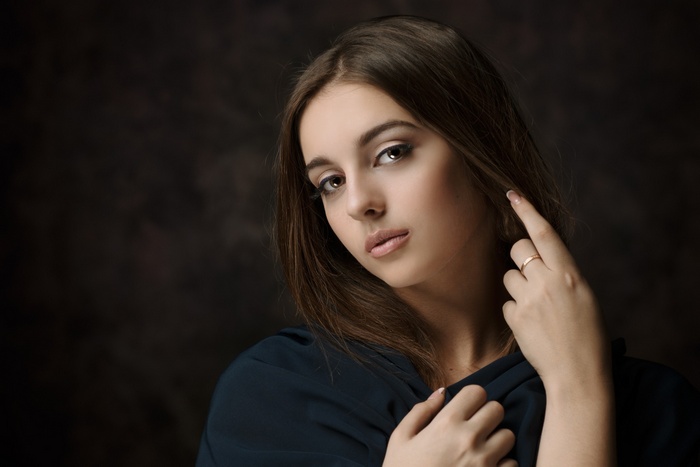 Portrait of a young woman with long brown hair