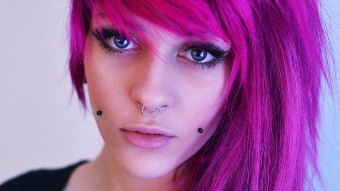 Woman with purple dyed hair and nose ring