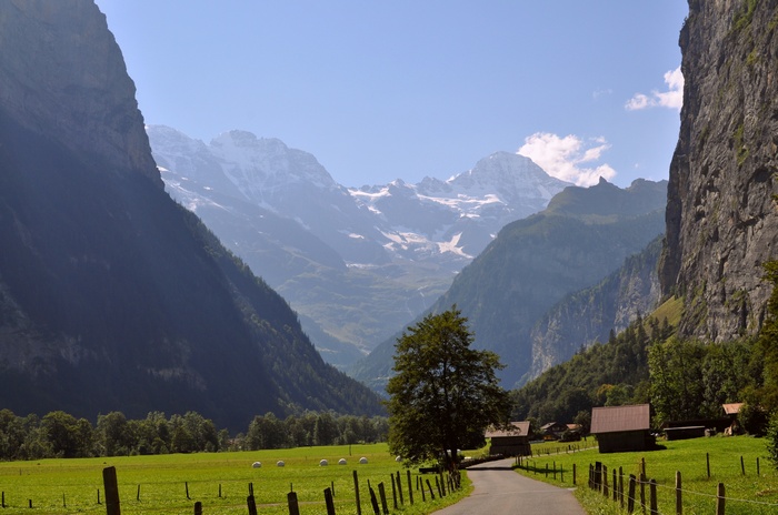 Valley with snow-capped mountains and traditional houses