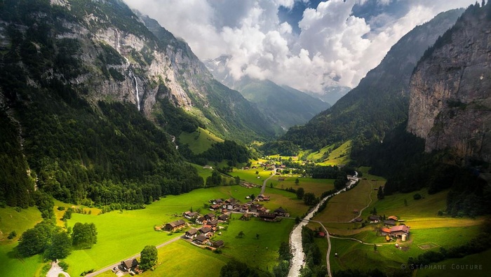 Valley with waterfalls and a village in the Swiss Alps