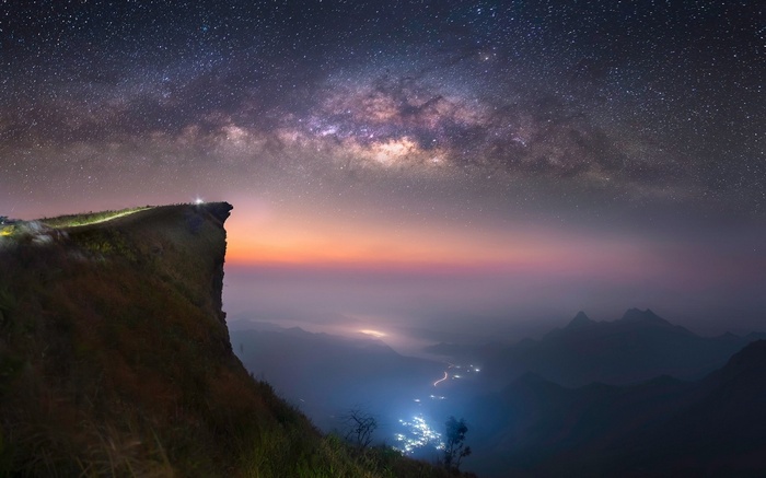 Milky Way over a mountain cliff at night