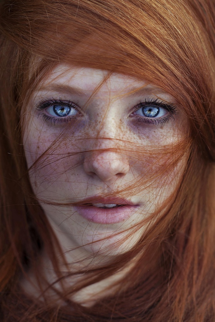 Redhead woman with blue eyes and freckles