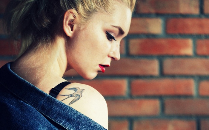 Woman with bird tattoo and red lipstick