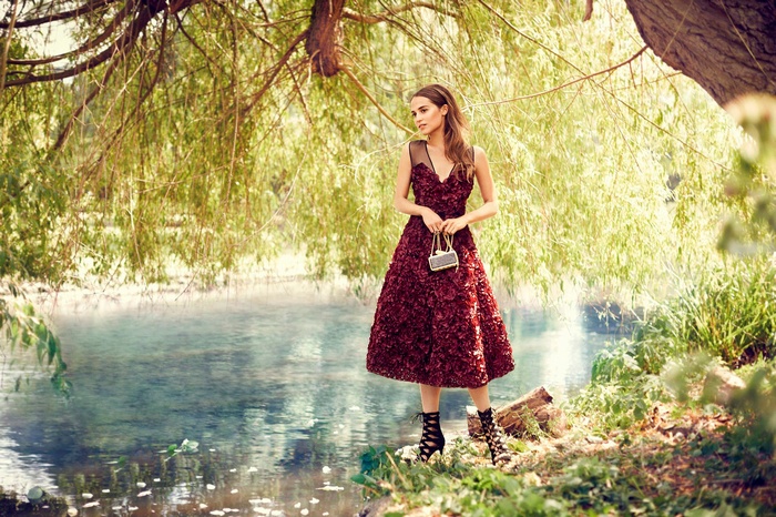 Alicia Vikander in a red dress by the water