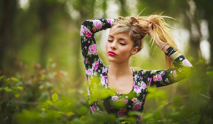 Woman with blonde hair in a floral dress