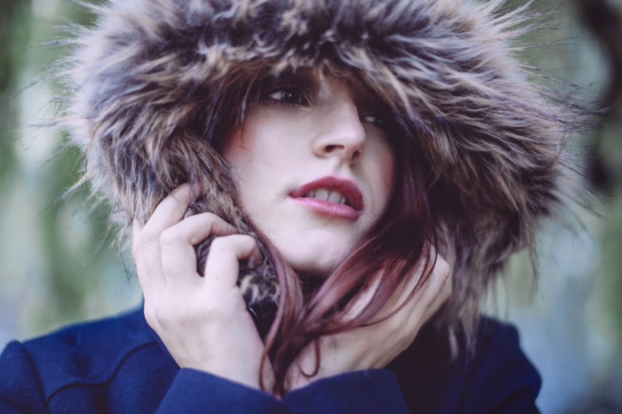 Woman wearing a fur-lined hood and dark coat