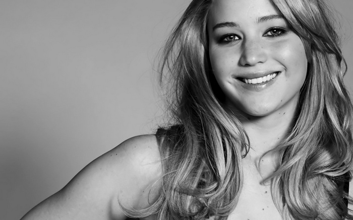 Jennifer Lawrence smiling in monochrome portrait
