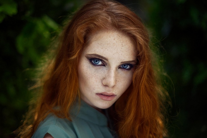 Redhead woman with blue eyes and freckles