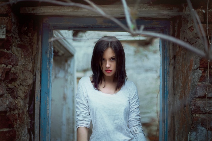 Woman standing in a doorway of ruins