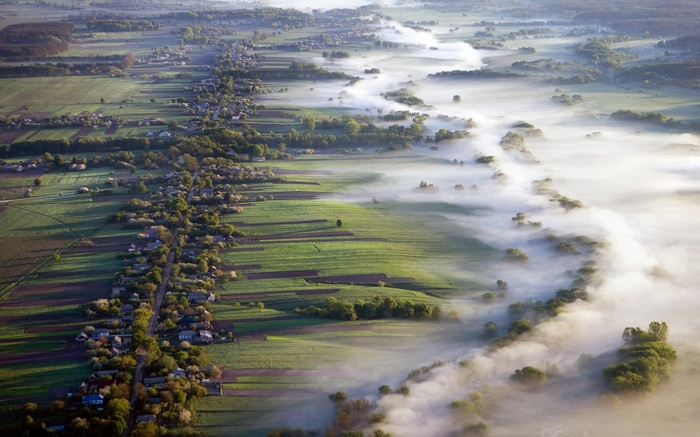 Aerial view of a village and misty river in Ukraine