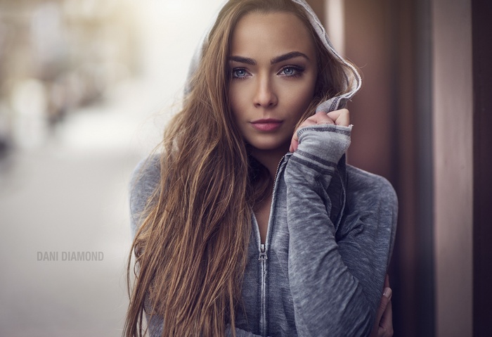 Portrait of a woman with blue eyes and long hair by Dani Diamond