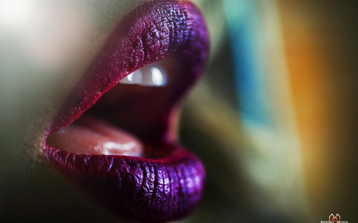 Close-up of woman's lips with purple lipstick by Sergey Minin