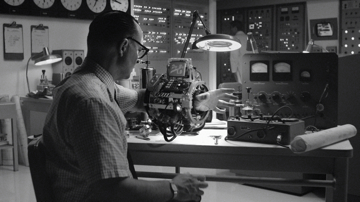 Man with Pip-Boy in a retro-futuristic lab
