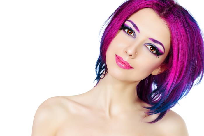 Woman with pink and blue dyed hair and makeup