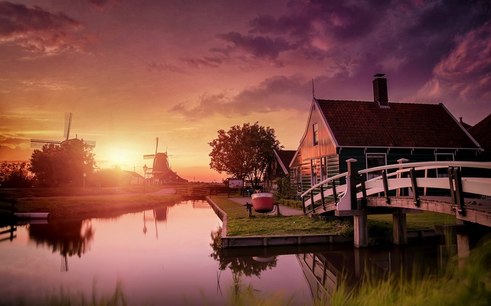 Sunset over Zaanse Schans with windmills and canal