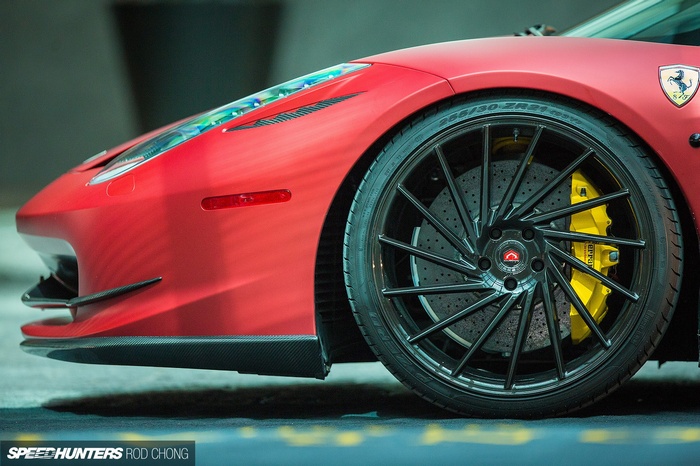 Red Ferrari car with custom black wheels