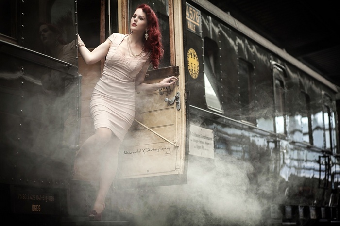 Woman in a dress exiting a train