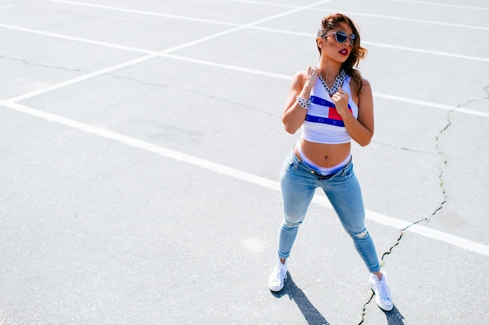 Tianna Gregory in ripped jeans and a crop top
