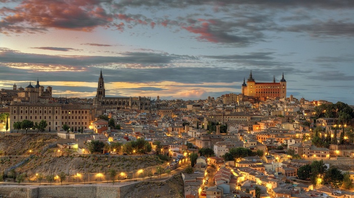 Toledo cityscape at dusk with cathedral and castle