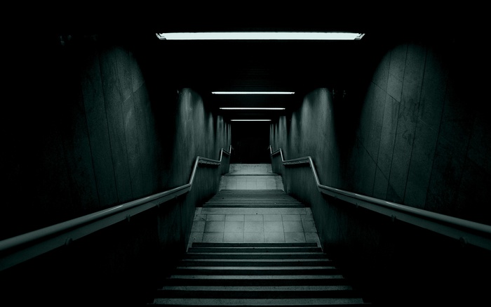 Dark underground stairs with fluorescent lights