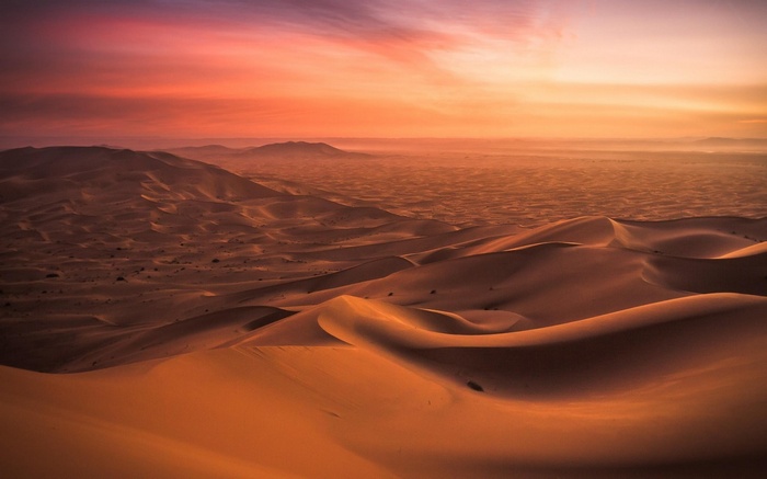 Sunset over the desert dunes in Morocco