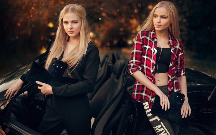 Alena and Alla Emelyanova with black plush toys