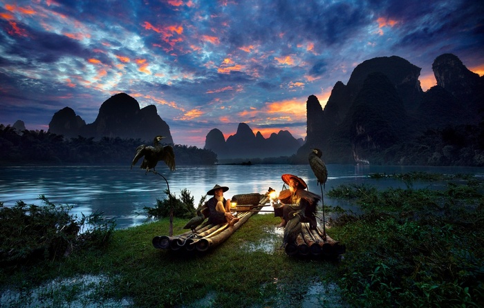 Fishermen with Cormorants on a River in China at Sunset
