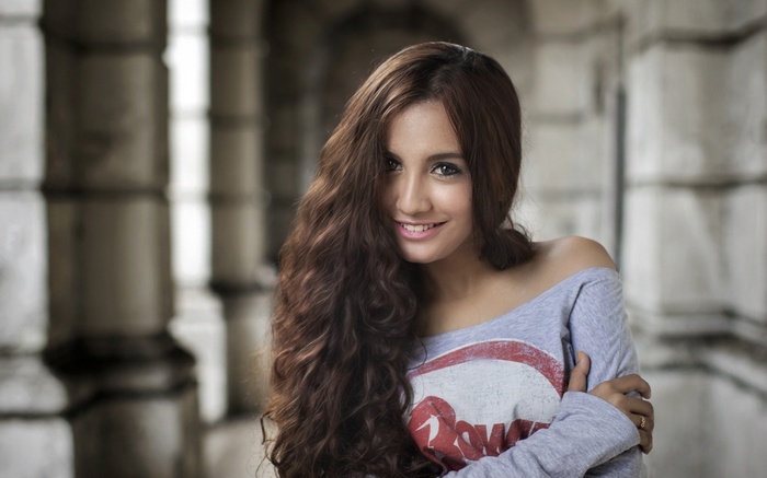 Woman with long curly hair smiling
