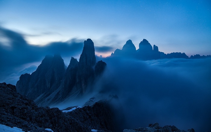 Misty mountain peaks at dusk in the Dolomites