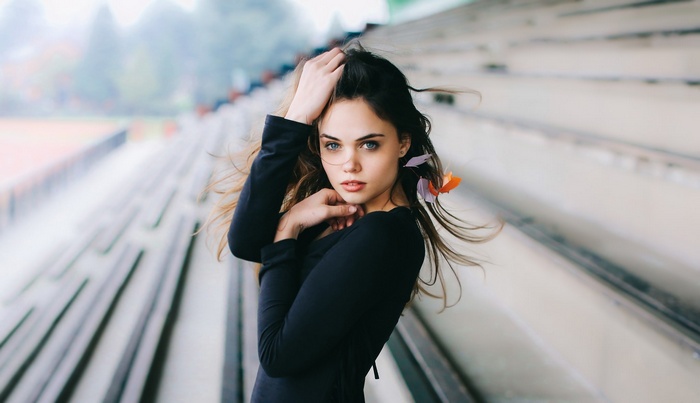 Woman with hands on head in stadium